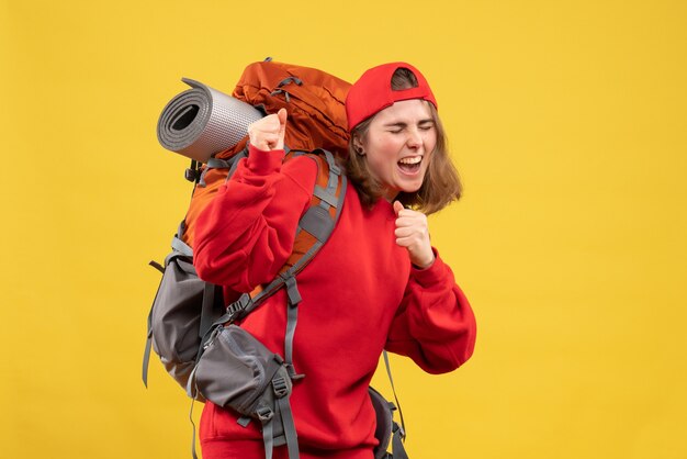 Front view rejoiced young tourist with backpack and red cap