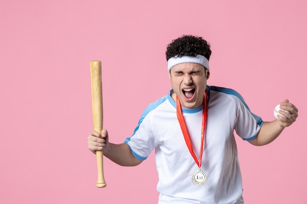 Front view rejoicing baseball player in sport clothes with medal