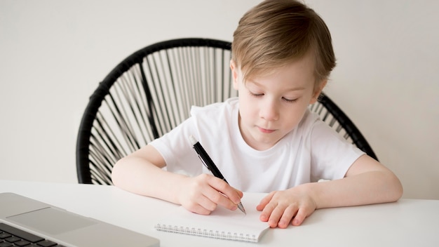 Free photo front view right-handed child writing