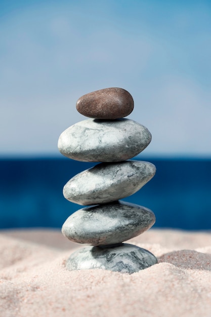 Front view of rocks stacked on beach sand