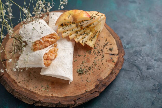 Front view rolled dough pita sliced with meat filling on dark blue desk