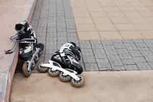 Free photo front view of roller blades on pavement with copy space