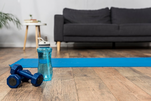 Front view of room with weights and water bottle