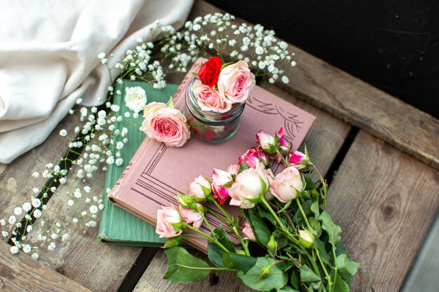 A front view roses books colored on the brown wooden floor