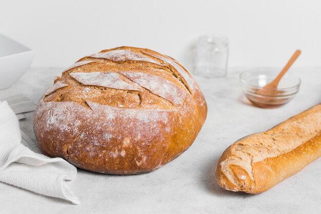 Front view round bread and french baguette