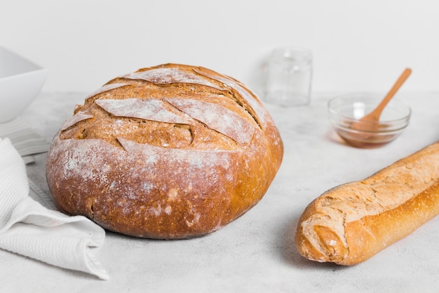 Front view round bread and french baguette