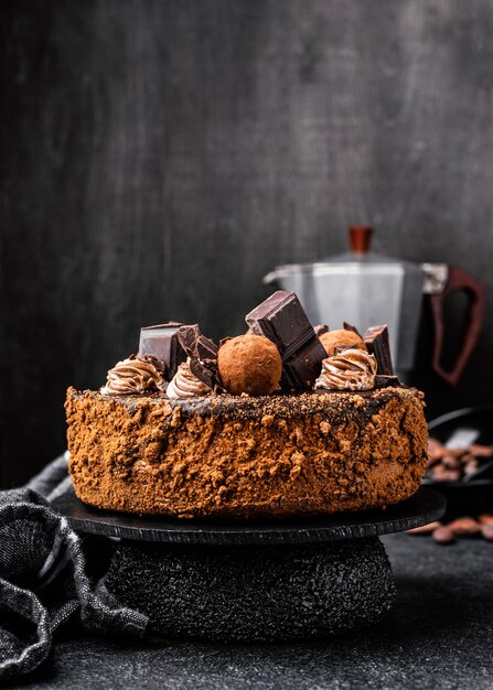 Front view of round chocolate cake on stand with copy space