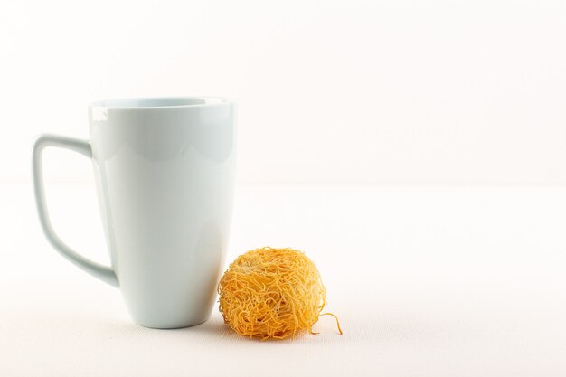 A front view round delicious cake sweet tasty round formed bake along with white cup isolated on the white background sweet sugar confectionery