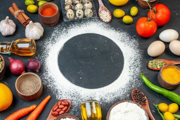 Front view round shaped flour with vegetables eggs and seasonings on dark background color cake white tea biscuit sugar cookie salad food