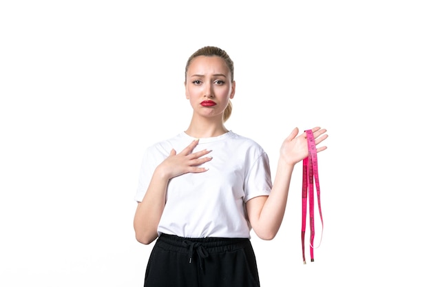 Front view sad young woman with measure tape on white background scale waist skin measuring slimming hip torso weight losing