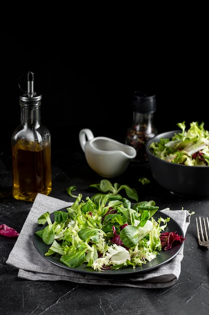 Front view salad arrangement with dark tableware