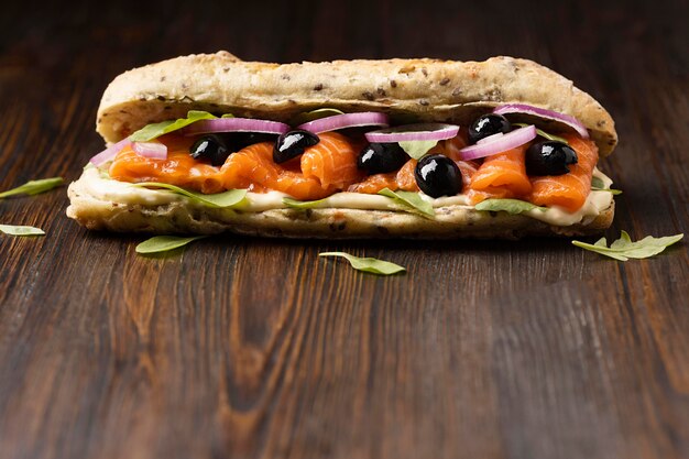 Front view of salmon sandwich with olives and copy space