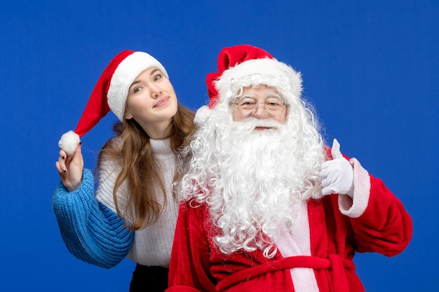 Front view santa claus along with young female on blue human christmas color new year holiday