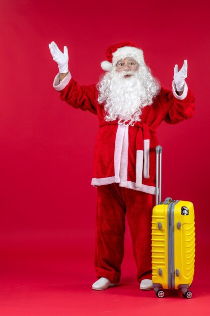 Front view santa claus carrying yellow bag preparing for trip