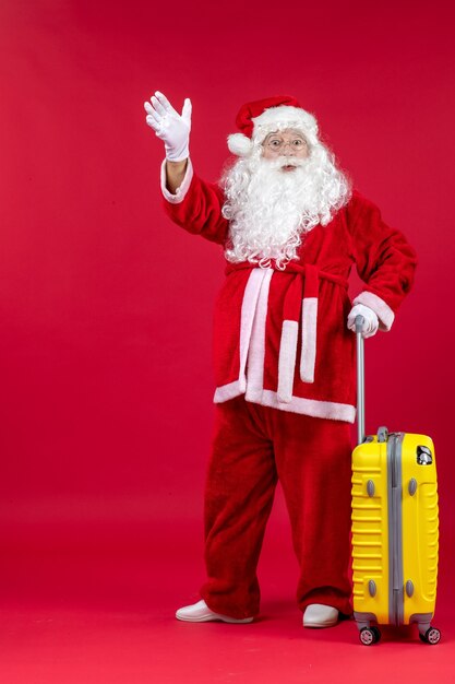 Front view santa claus carrying yellow bag preparing for trip