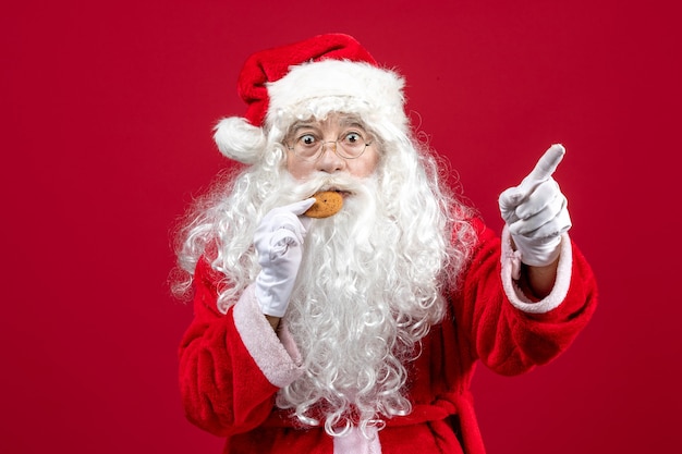 Front view santa claus eating biscuits