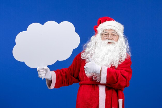 Front view santa claus holding big cloud shaped sign on a blue snow color christmas