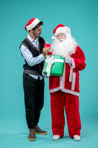 Front view santa claus holding present with young male