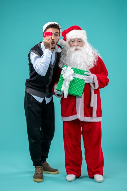 Front view santa claus holding present with young male