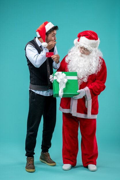 Front view santa claus holding present with young male