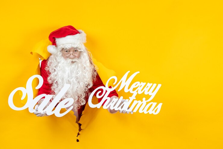 無料Photo 販売とメリークリスマスの執筆を保持している正面のサンタクロース