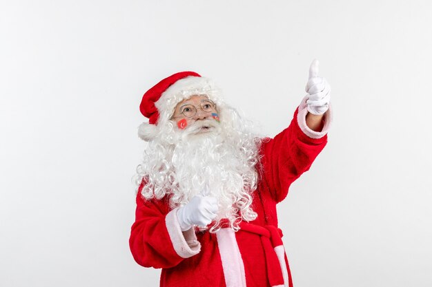 Front view of santa claus with azerbaijani flag paint on his face on a white wall