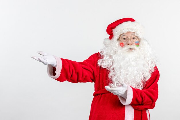 Front view of santa claus with azerbaijani and turkish flag paints on his face on white wall