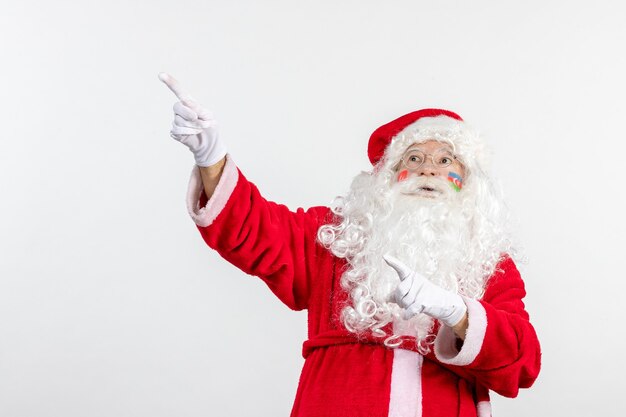 Front view of santa claus with azerbaijani and turkish flag paints on his face on white wall