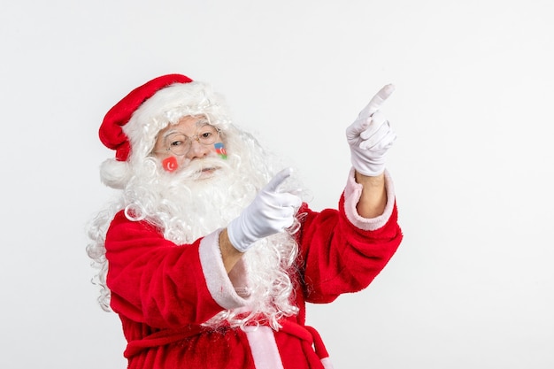 Front view of santa claus with azerbaijani and turkish flag paints on his face on white wall