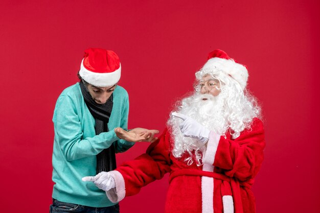 Front view santa claus with young male interacting