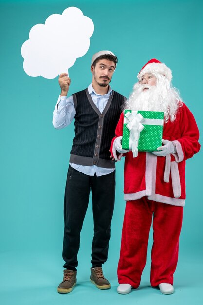 Front view santa claus with young male whos holding white cloud sign on a blue background