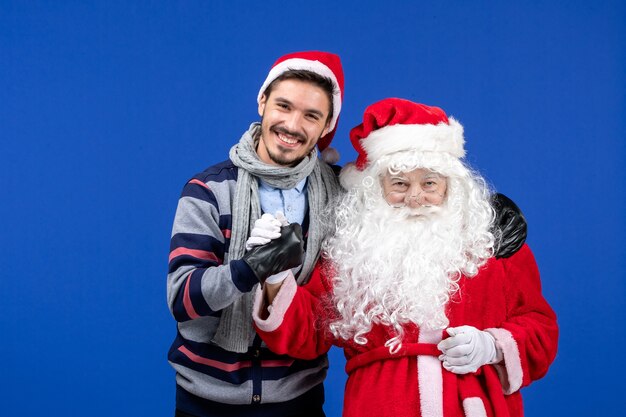 Free photo front view santa claus with young male