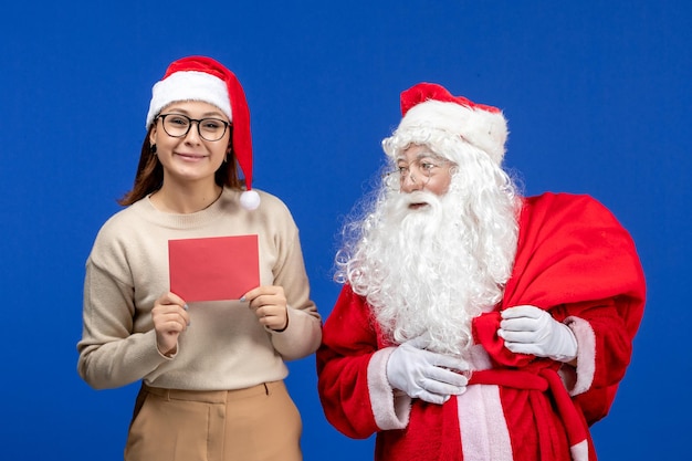 Front view santa claus and young female with letter on blue holiday spirit emotion christmas snow