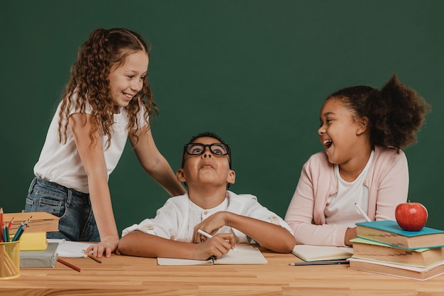 Free photo front view school kids laughing