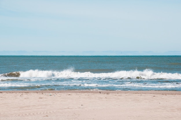  front view sea waves hitting the shore