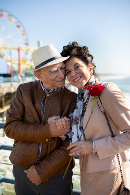 Front view of senior couple on a date at the amusement park