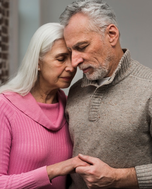 Free photo front view senior couple holding hands