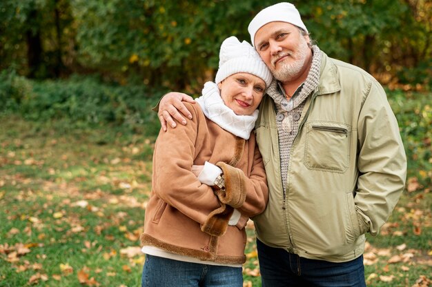 Front view senior couple outdoor hugging