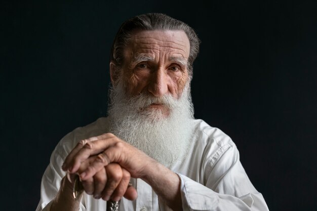 Front view senior man posing inside