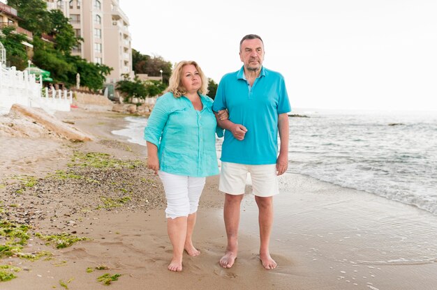 Front view of senior tourist couple at the beach