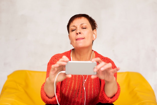 Front view senior woman taking selfies