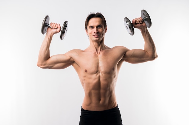 Free photo front view of shirtless athletic man with weights