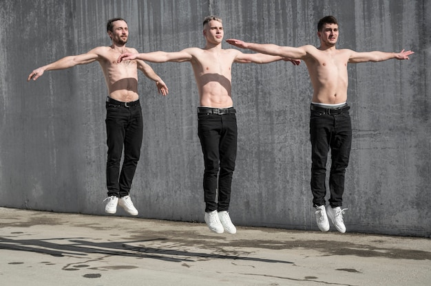 Front view of shirtless hip hop dancers