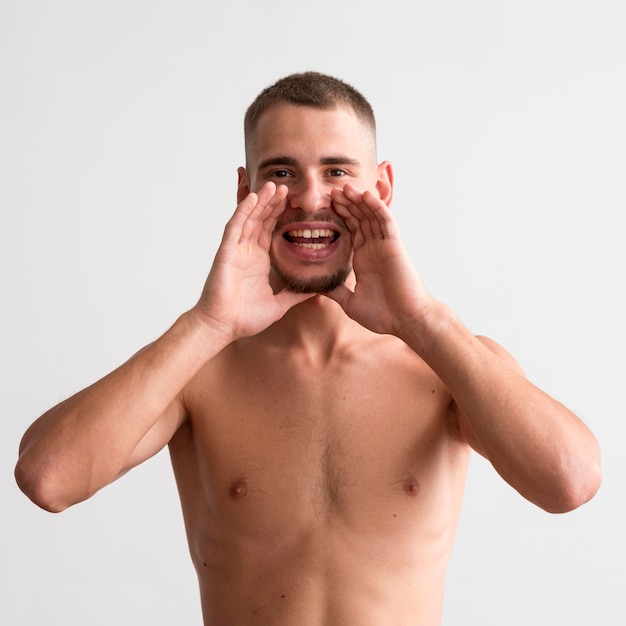 Front view of shirtless man shouting