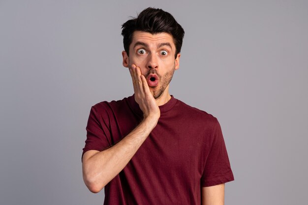 Front view of shocked man with open mouth