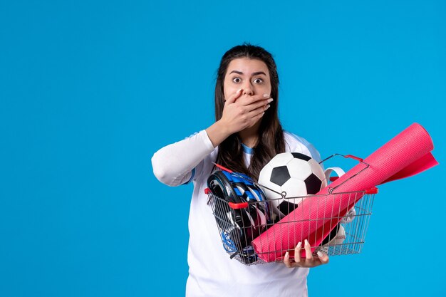 Front view shocked young female with basket full of sport things