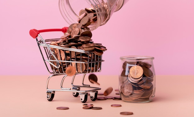 Front view of shopping cart with lots of coins and jar