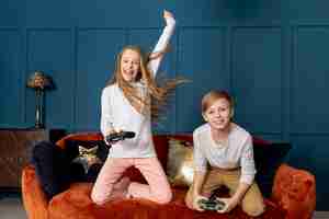 Free photo front view sibling playing together video games