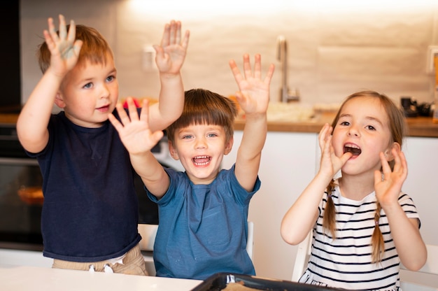 Front view of siblings cooking at home