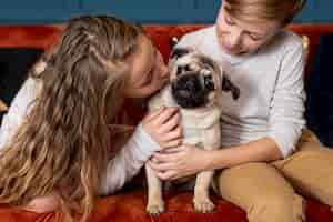 Free photo front view siblings spending time together with their dog